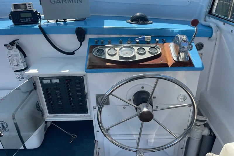 Slide: The Image of Helm of 1966 Webbers Cove 34 boat with steering wheel and navigation instruments. - 32