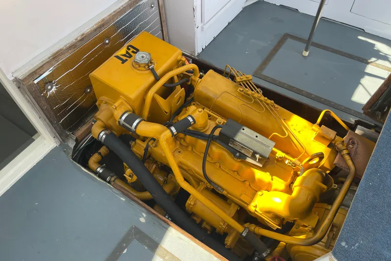 Slide: The Image of Engine compartment of a 1966 Webbers Cove 34 boat with a yellow CAT engine. - 48