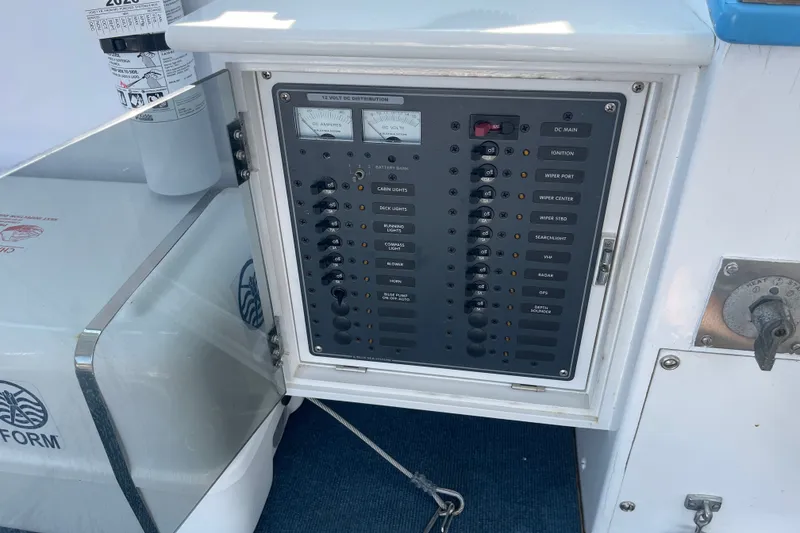 Slide: The Image of Electrical panel on a 1966 Webbers Cove 34 boat, featuring various switches and controls. - 31