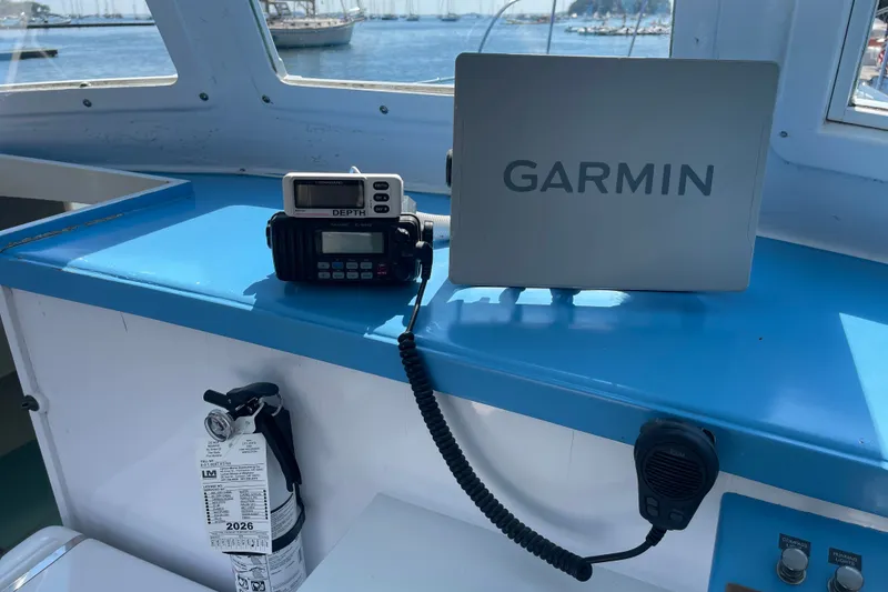Slide: The Image of Boat dashboard with Garmin GPS, radio, and fire extinguisher on a 1966 Webbers Cove 34. - 34