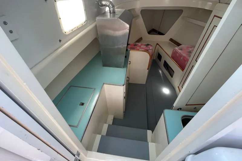 Slide: The Image of Interior of a 1966 Webbers Cove 34 boat, featuring compact cabin space. - 38