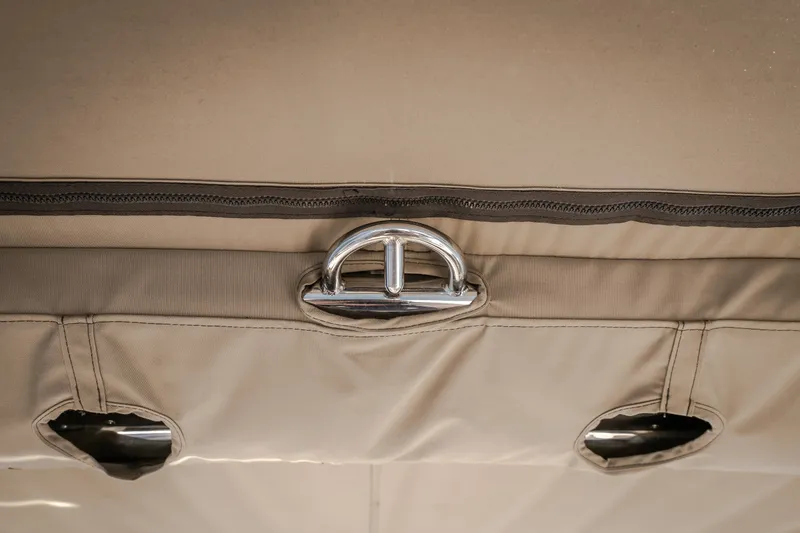 Slide: The Image of Close-up of a 2010 Cobalt 302 boat's beige upholstery with metal fastener detail. - 32