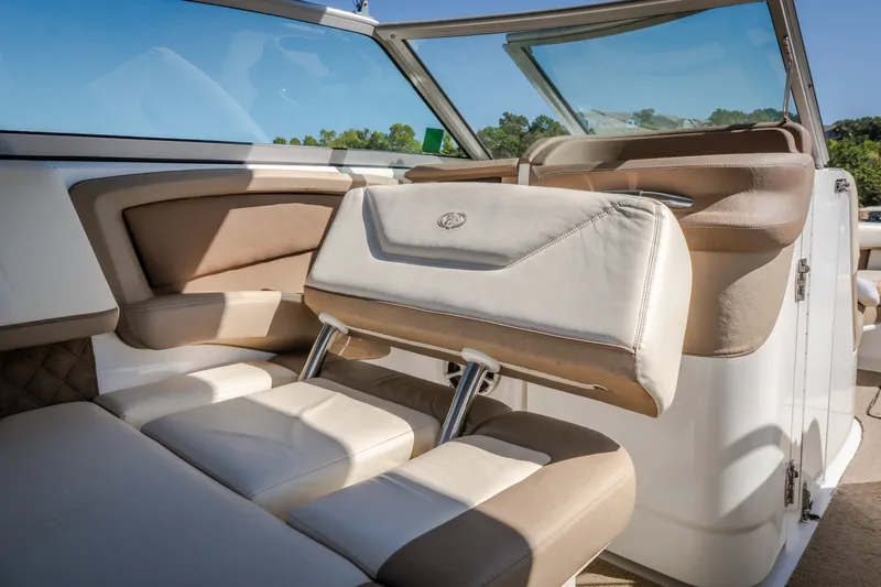 Slide: The Image of Luxurious interior of a 2010 Cobalt 302 boat with beige leather seating. - 33