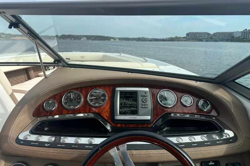 Slide: The Image of Dashboard of a 2010 Cobalt 302 boat with Garmin navigation on a lake. - 9