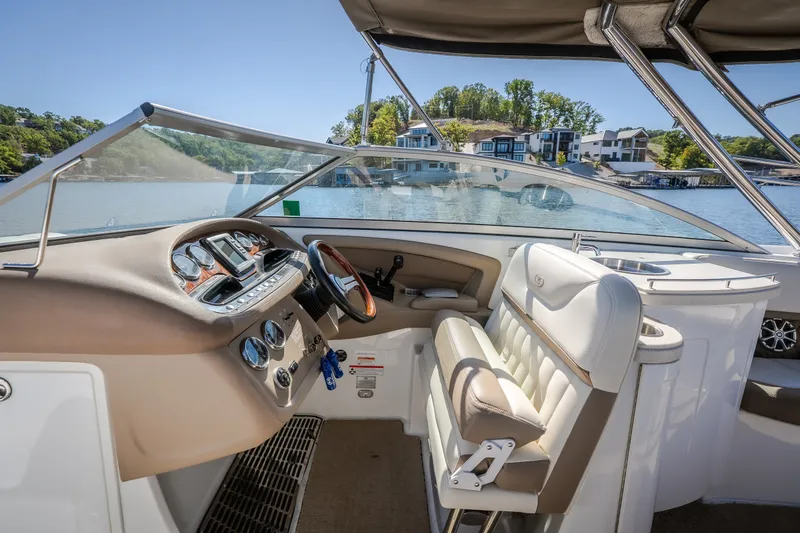 Slide: The Image of Cockpit of a 2010 Cobalt 302 boat with luxurious seating and scenic lake view. - 25