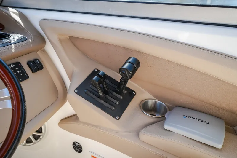 Slide: The Image of Control panel of a 2010 Cobalt 302 boat with Garmin device and cup holder. - 38