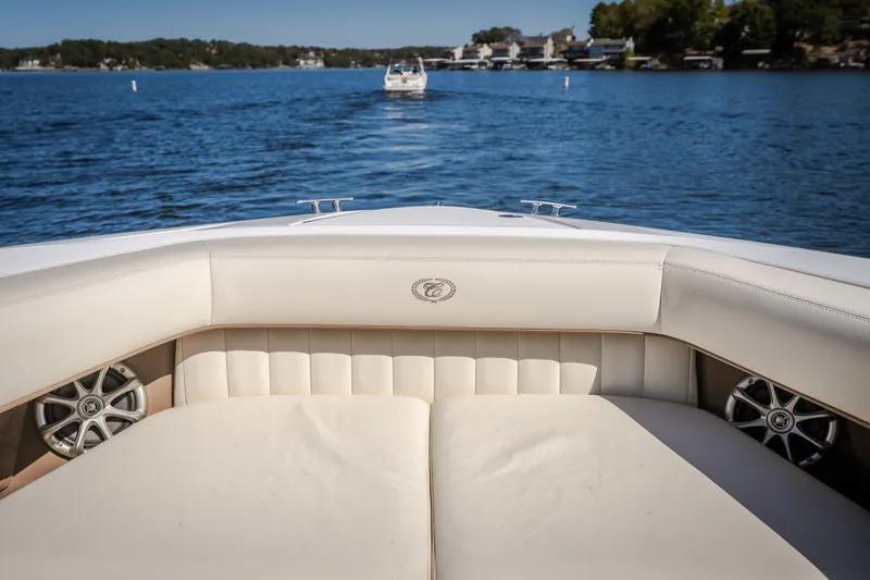 Slide: The Image of 2010 Cobalt 302 boat interior with luxurious seating on a serene lake. - 17