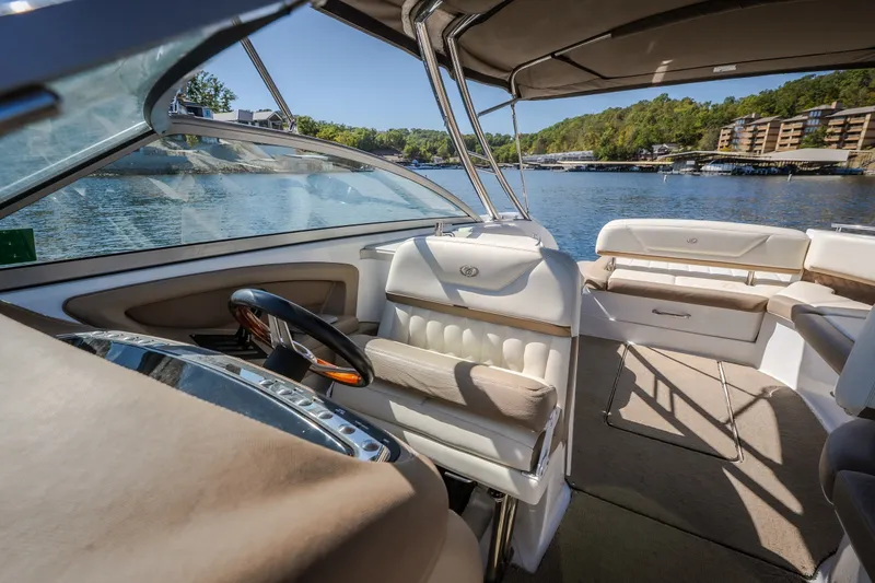 Slide: The Image of Interior of a 2010 Cobalt 302 boat with luxurious seating and scenic lake view. - 23
