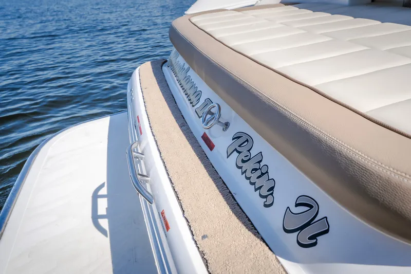 Slide: The Image of 2010 Cobalt 302 boat with cushioned seating, docked on calm water. - 37