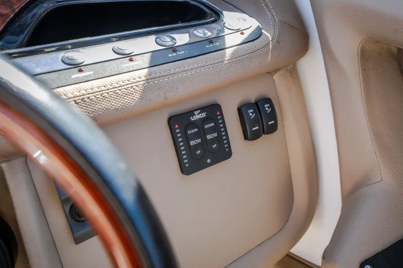 Slide: The Image of Control panel of a 2010 Cobalt 302 boat with steering wheel and switches. - 46