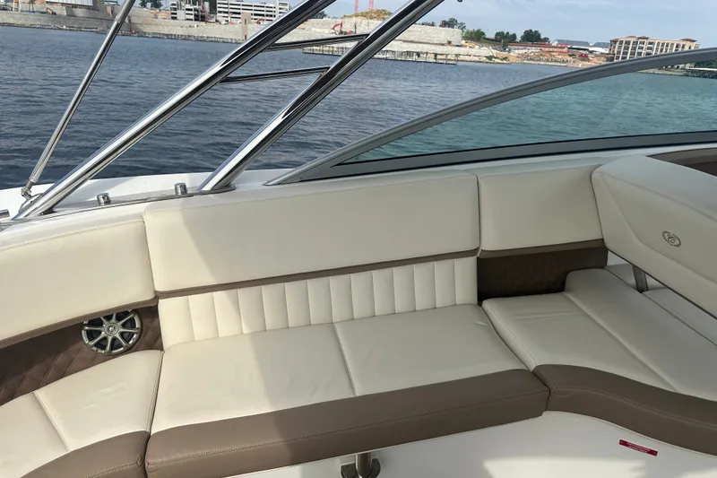 Slide: The Image of Luxurious seating on a 2010 Cobalt 302 boat, featuring cream and brown upholstery. - 6