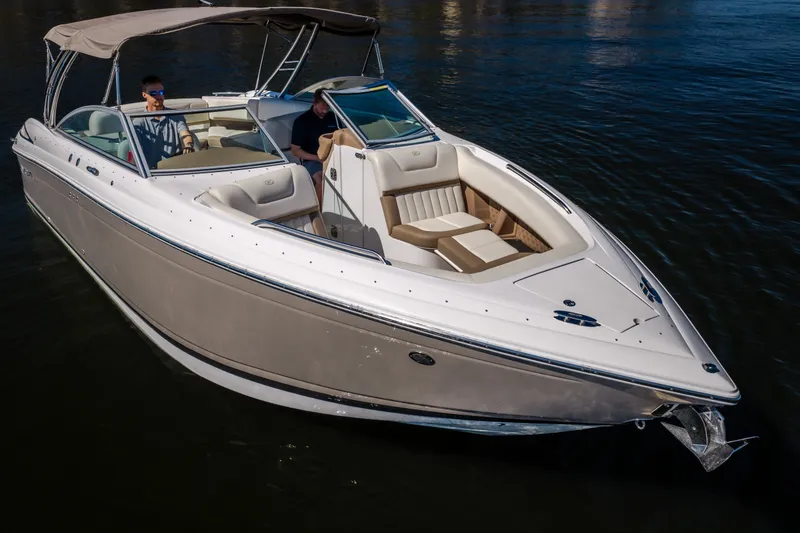 Slide: The Image of 2010 Cobalt 302 boat cruising on calm water with two passengers. - 3