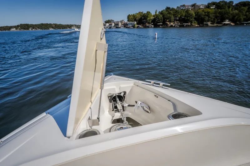 Slide: The Image of 2010 Cobalt 302 boat cruising on a scenic lake with open anchor compartment. - 18
