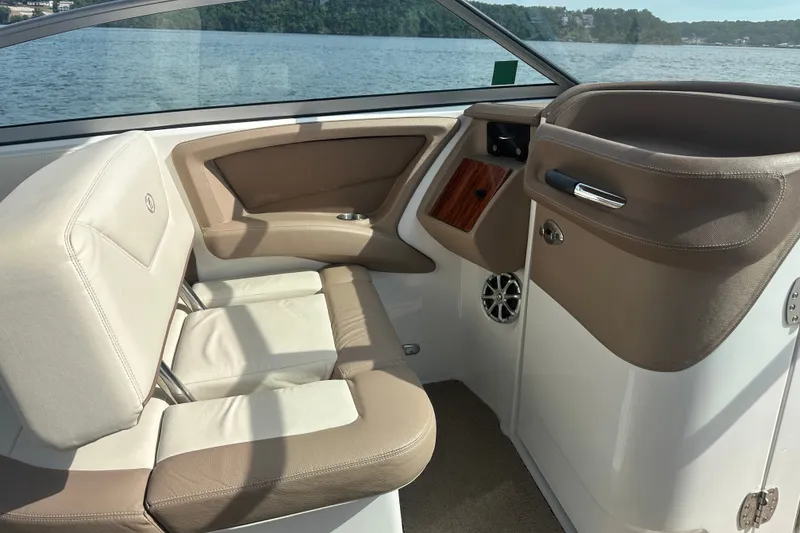 Slide: The Image of Interior of a 2010 Cobalt 302 boat with beige seating and lake view. - 12