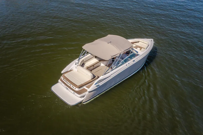 Slide: The Image of 2010 Cobalt 302 boat on calm water, featuring a sleek design and spacious seating. - 8