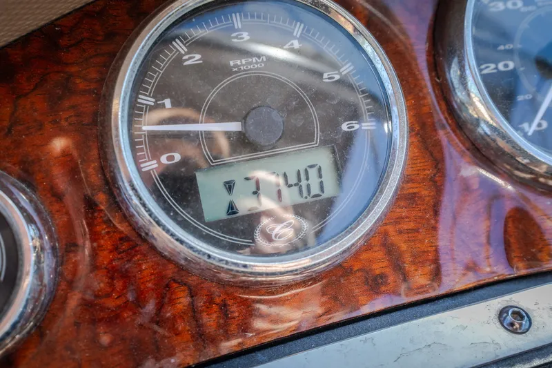 Slide: The Image of Close-up of a 2010 Cobalt 302 RPM gauge displaying 3740 RPM on a wooden dashboard. - 39