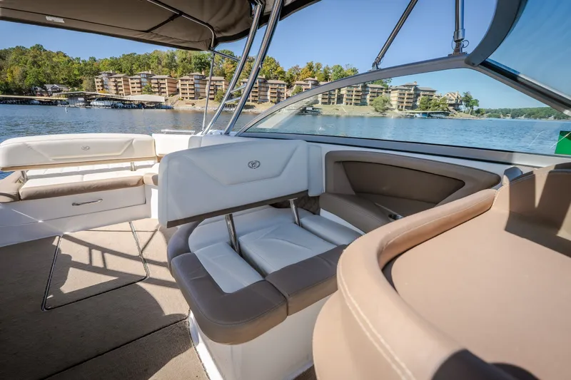 Slide: The Image of Interior of a 2010 Cobalt 302 boat with luxurious seating and scenic lake view. - 24