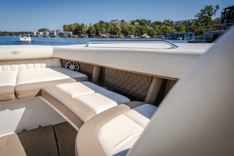 Slide: The Image of Luxurious interior of a 2010 Cobalt 302 boat with beige seating, on a scenic lake. - 16