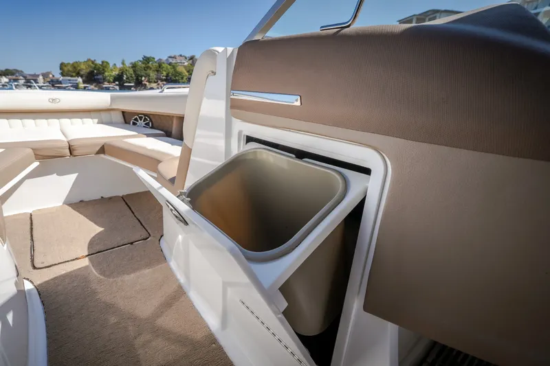 Slide: The Image of Interior of a 2010 Cobalt 302 boat featuring a built-in storage compartment. - 13