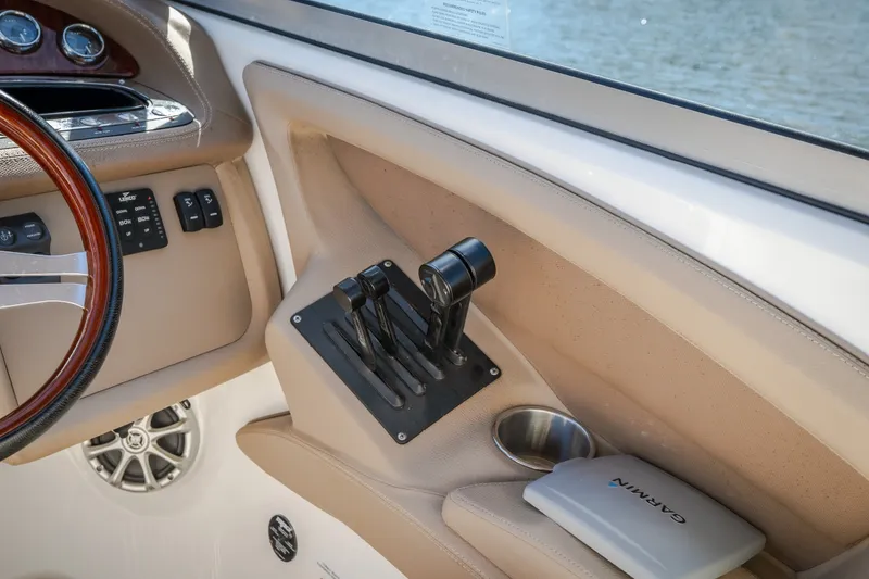 Slide: The Image of Interior of a 2010 Cobalt 302 boat showing controls and Garmin device. - 42