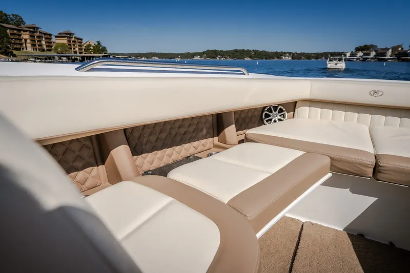 Slide: The Image of Luxurious interior of a 2010 Cobalt 302 boat with beige seating and lake view. - 15