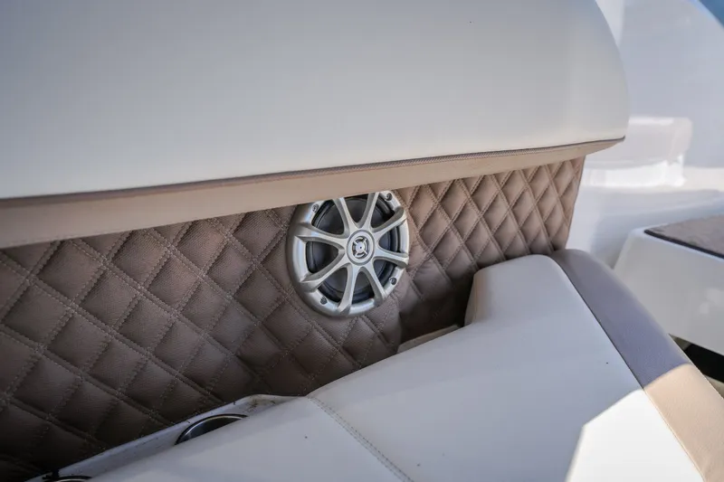 Slide: The Image of Luxurious interior of 2010 Cobalt 302 boat with quilted upholstery and speaker detail. - 48