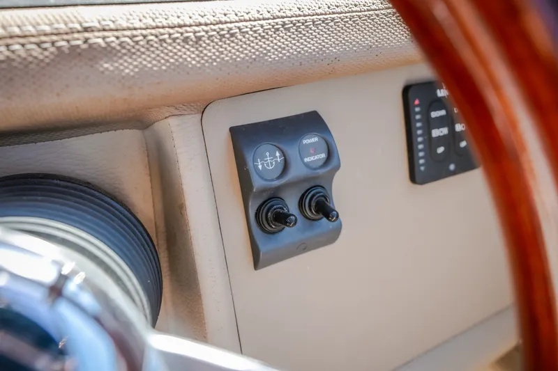 Slide: The Image of Dashboard controls of a 2010 Cobalt 302 boat, featuring switches and indicators. - 47