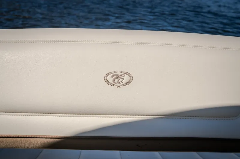 Slide: The Image of Cobalt 302 boat seat with embroidered logo, 2010 model, against a water backdrop. - 49