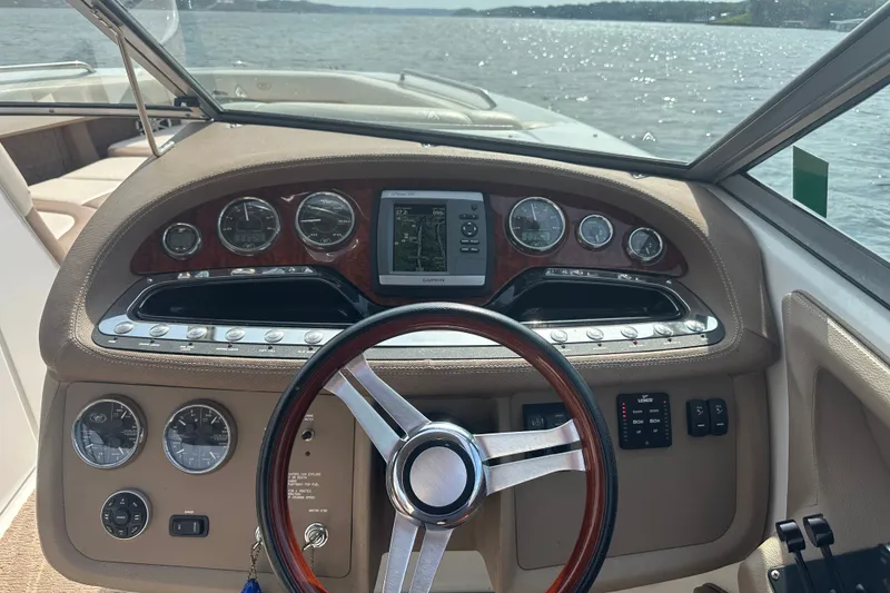 Slide: The Image of Steering console of a 2010 Cobalt 302 boat with gauges and navigation system. - 11