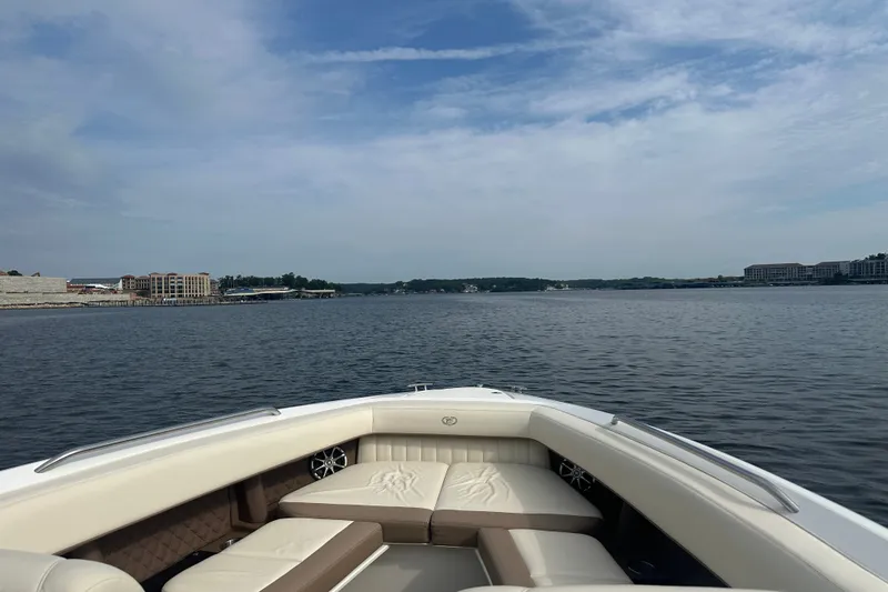 Slide: The Image of 2010 Cobalt 302 boat on a calm lake with scenic shoreline views. - 3