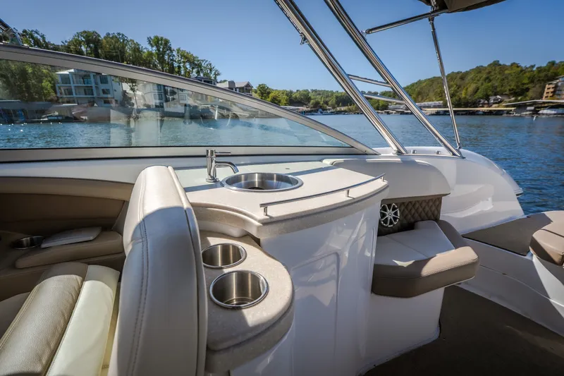 Slide: The Image of Luxurious interior of a 2010 Cobalt 302 boat with seating and a built-in sink. - 29