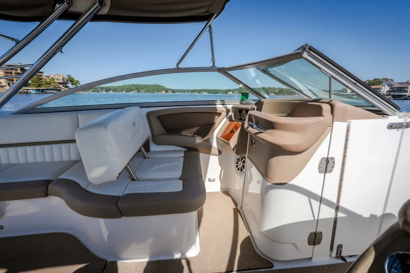 Slide: The Image of Interior of a 2010 Cobalt 302 boat with seating and steering wheel. - 26