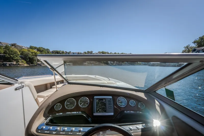 Slide: The Image of Cobalt 302 boat dashboard view, cruising on a sunny lake, 2010 model. - 44