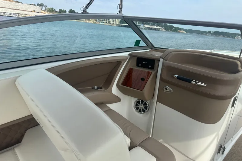 Slide: The Image of Interior of a 2010 Cobalt 302 boat with beige seating and wood accents. - 7