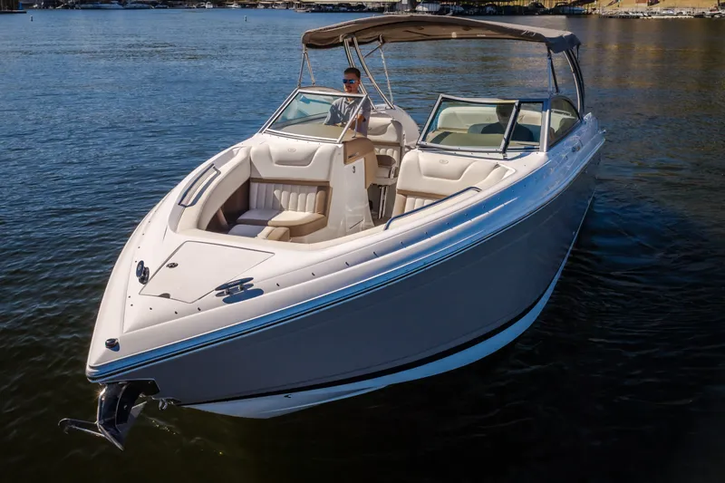 Slide: The Image of 2010 Cobalt 302 boat on calm water, featuring sleek design and spacious seating. - 4