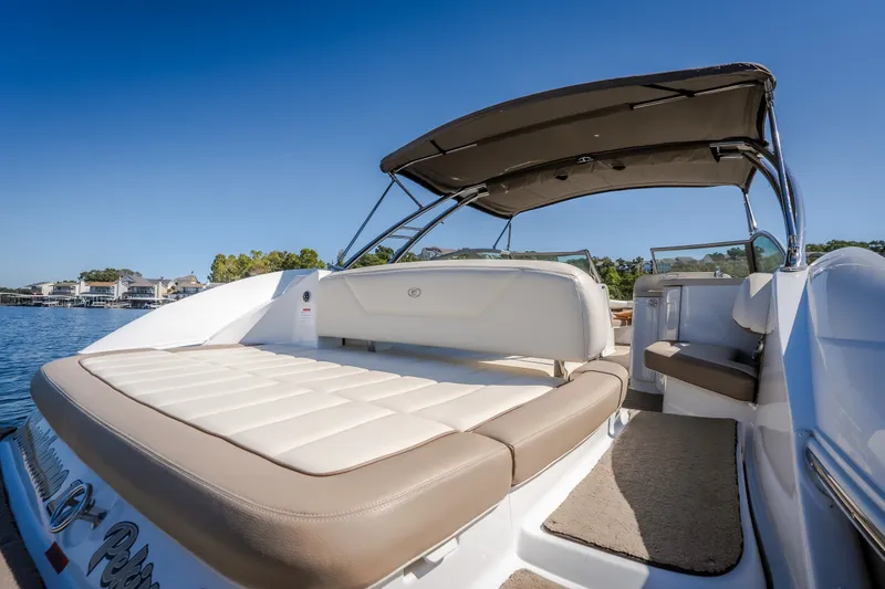 Slide: The Image of 2010 Cobalt 302 boat with sunpad and canopy on a sunny day. - 36