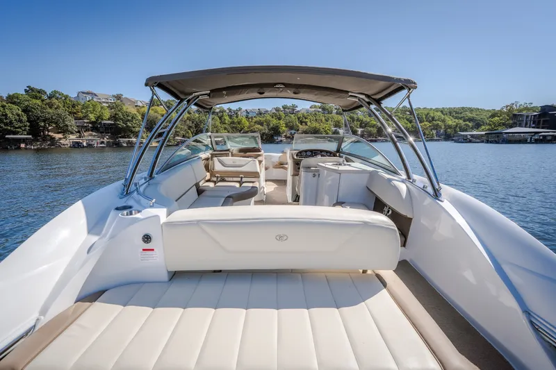 Slide: The Image of 2010 Cobalt 302 boat with spacious seating on a serene lake. - 35