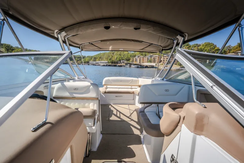 Slide: The Image of 2010 Cobalt 302 boat interior with seating, canopy, and lake view. - 22