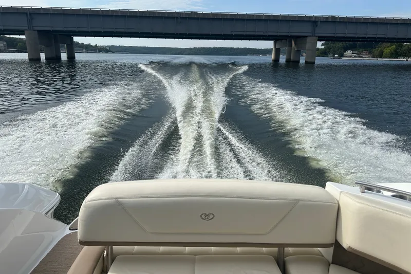 Slide: The Image of Rear view from a 2010 Cobalt 302 boat cruising under a bridge on a lake. - 4