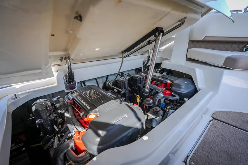 Slide: The Image of Engine compartment of a 2010 Cobalt 302 boat, featuring Volvo Penta engines. - 51