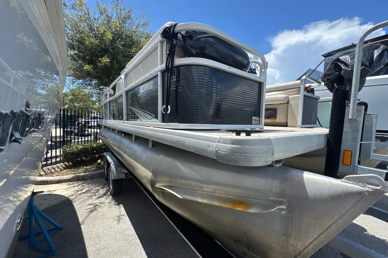 Slide: The Image of 2017 Godfrey Sweetwater Sunrise 22 pontoon boat parked outdoors. - 2