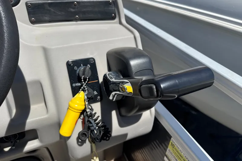 Slide: The Image of Control panel of a 2017 Godfrey Sweetwater Sunrise 22 boat with ignition keys. - 15