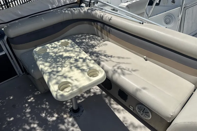 Slide: The Image of Interior seating of 2017 Godfrey Sweetwater Sunrise 22 boat with table and cup holders. - 10