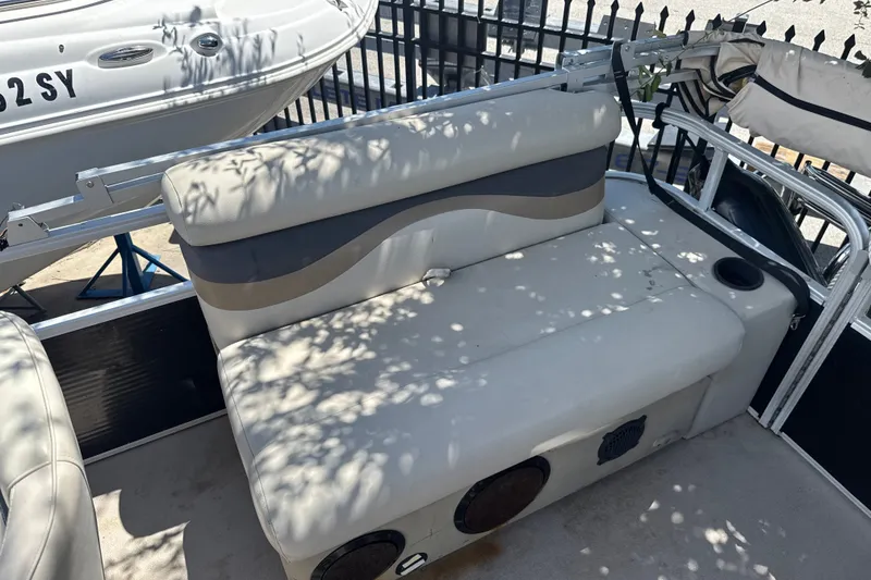 Slide: The Image of 2017 Godfrey Sweetwater Sunrise 22 boat interior with cushioned seating and cup holders. - 9