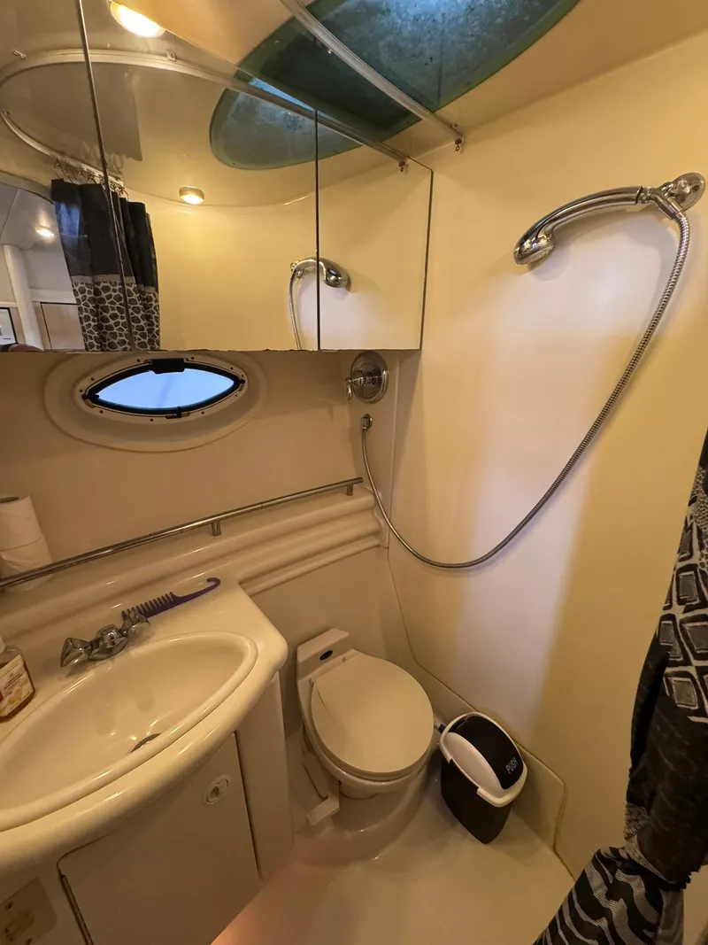Slide: The Image of The image shows a boat bathroom with a sink, toilet, and shower. - 18