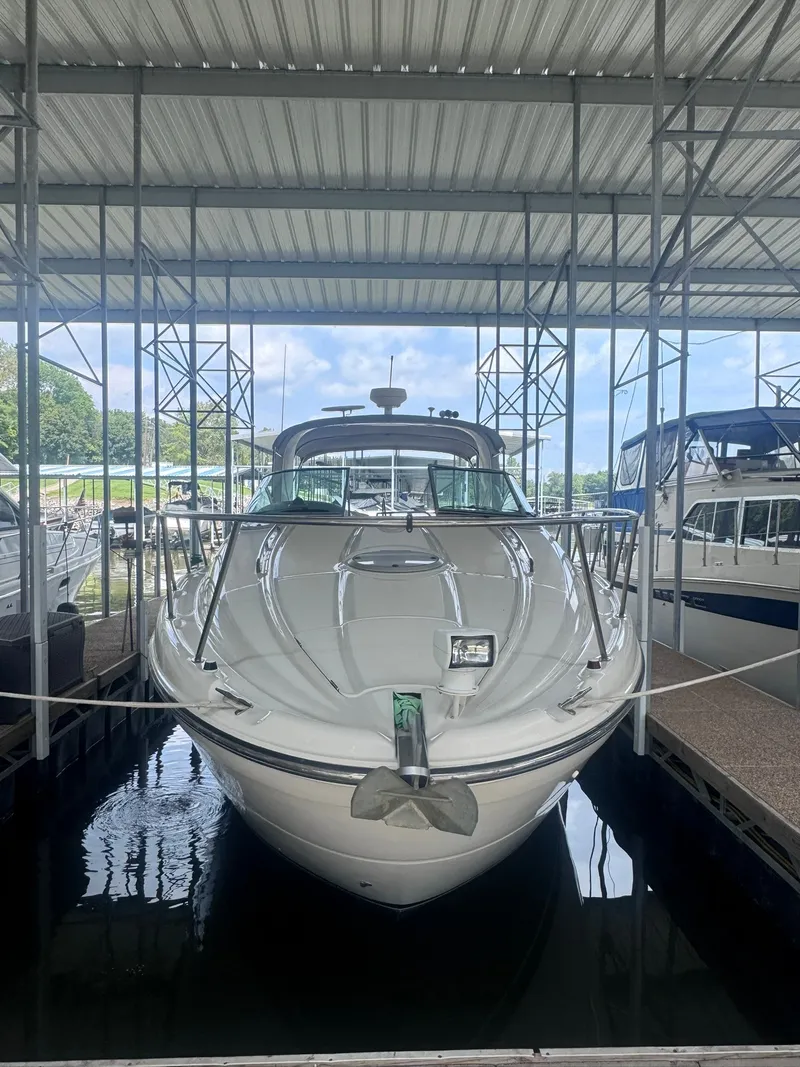 The Image of A 2001 Maxum 3500 SCR is docked in a covered boat slip. - 0