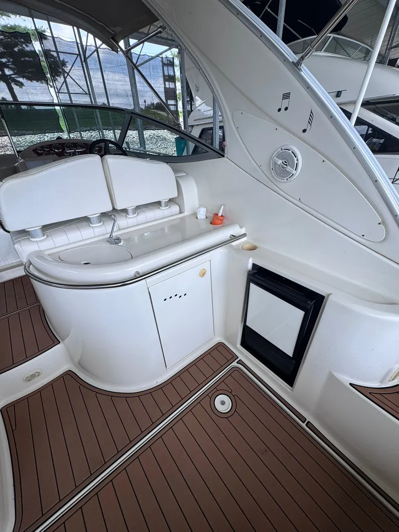 Slide: The Image of The image shows the cockpit of a 2001 Maxum 3500 SCR with a small sink and refrigerator. - 10