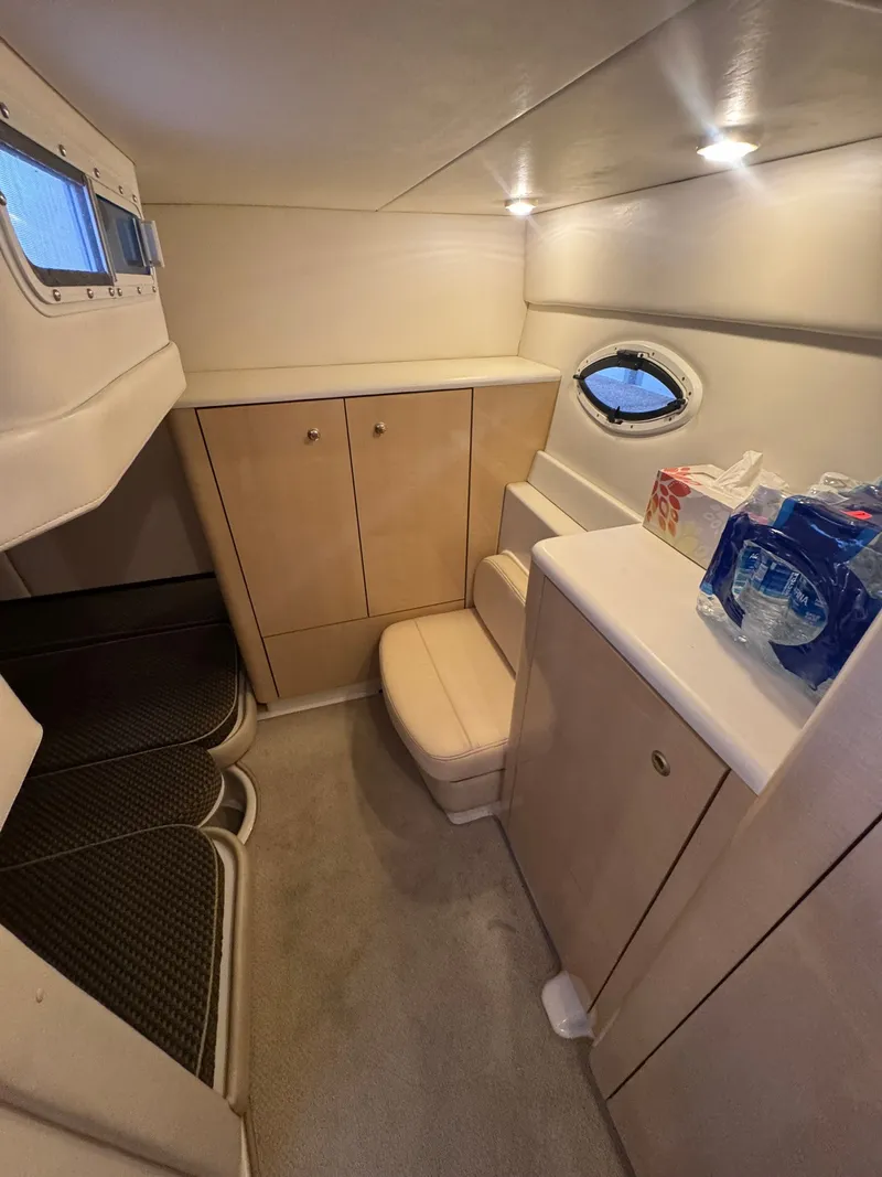 Slide: The Image of Interior of a 2001 Maxum 3500 SCR with seating, cabinets, and a porthole. - 15