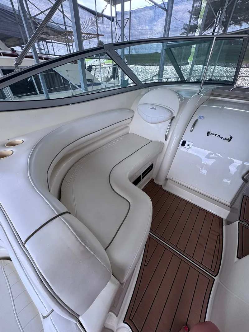 Slide: The Image of The image shows the cockpit of a 2001 Maxum 3500 SCR with curved white seating and wood flooring. - 6