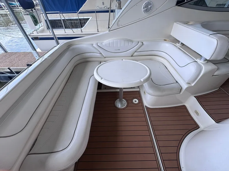 Slide: The Image of The image shows the cockpit of a 2001 Maxum 3500 SCR with white upholstery and a round table. - 11